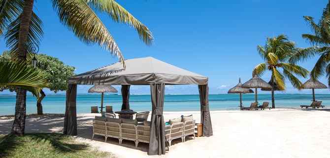 Beach with tent and chairs.